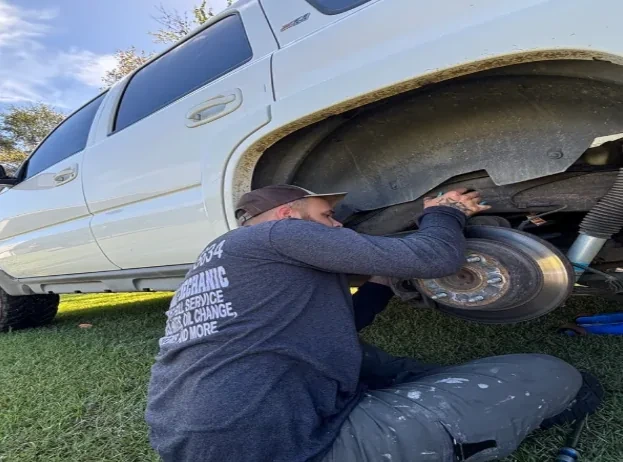 Fatboy mechanic working on a vehicle outdoors